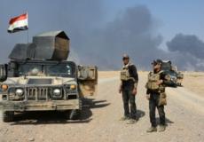 قوات عراقية خلال اشتباكات مع مسلحي تنظيم "الدولة الإسلامية" بضواحي القيارة.