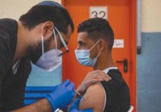 تطعيم عمال فلسطين بفيروس كورونا