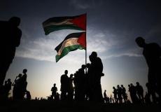 فلسطينيون يرفعون علم فلسطين