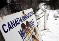 لافتة تحذيرية على الحدود الكندية الأميركية