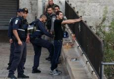 قوات الاحتلال تفتش شاباً فلسطينياً