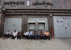 موظفون أمام بنك فلسطين في غزة ينتظرون صرف رواتبهم