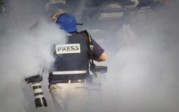 صحفي فلسطيني يتعرض لقنابل الغاز الاسرائيلية