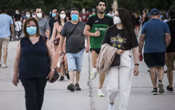 المارة في الشوارع يرتدون الكمامات الواقية تحسبًا من فيروس كورونا