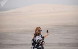 فتاة تلتقط سيلفي في صحراء خور العديد في الدوحة قطر
