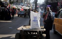 لاجئ يتسلم مساعدة غذائية من الأونروا في غزة