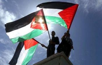 شبان يحملون أعلام فلسطين