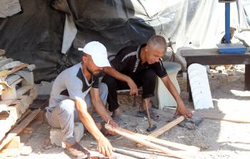 عبد الله وعنتر العجلة: من تجارة الأقمشة إلى بيع الخشب في غزة