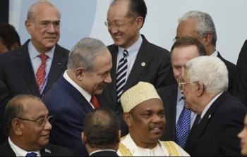 الرئيس عباس يصافح نتنياهو في باريس