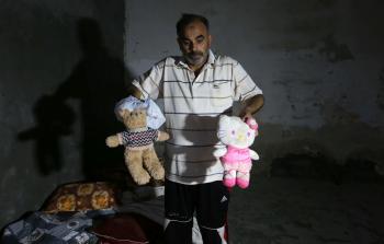 فلسطيني يحمل الألعاب الطفلة بيان أبو خماش