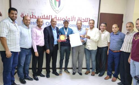 غزة: اللجنة الأولمبية تكرم سعيد تمراز وبطل الترايثلون محمد عطاالله