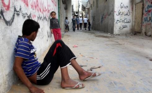 أرشيف / طفل في يجلس على مدخل مخيم بغزة 