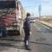 شرطي مرور يقف أمام شاحنة نقل احترقت على جسر وادي غزة