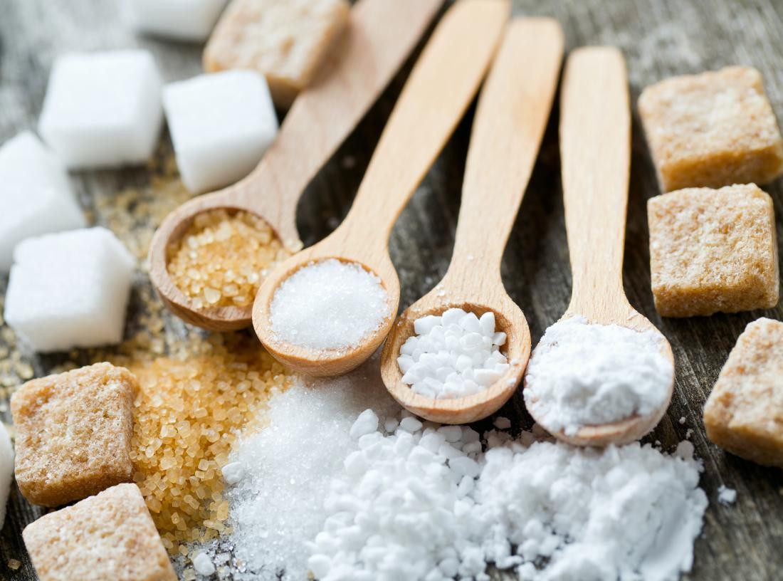 brown-icing-granular-and-white-sugar-on-wooden-spoons-and-in-cubes.jpg